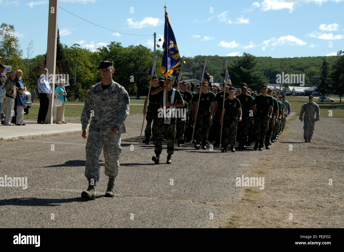 Michigan Youth Challenge Academy cadre and cadets march in the annual pass in review of the troops ceremony at Camp Grayling Joint Maneuver Training Center, Grayling, Mich., Aug. 21, 2015. Michigan Lt. Gov. Brian Calley was the keynote speaker and reiterated his thanks to the Soldiers and their families. (U.S. Air National Guard photo by Master Sgt. Denice Rankin/Released) Stock Photo