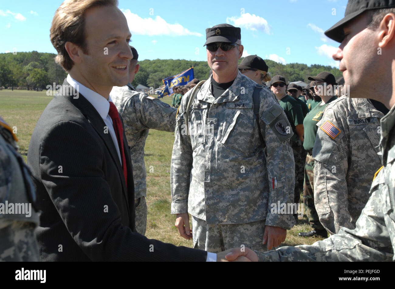 Lt. Gov. Brian Calley speaks to Michigan Youth Challenge Academy cadre after the annual Pass and Review of the Troops ceremony at Camp Grayling Joint Maneuver Training Center, Grayling, Mich., Aug. 21, 2015. Calley was the key-note speaker and reiterated his thanks to the Soldiers and their families. (U.S. Air National Guard photo by Master Sgt. Denice Rankin/Released) Stock Photo