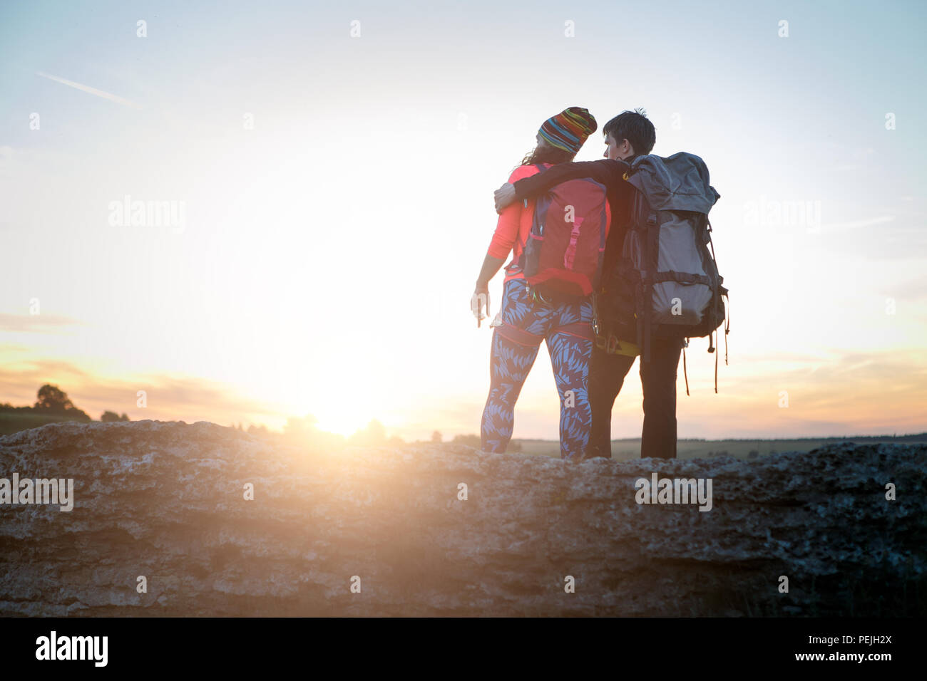 Picture of photo from back of hugging man and woman of tourists on hill ...