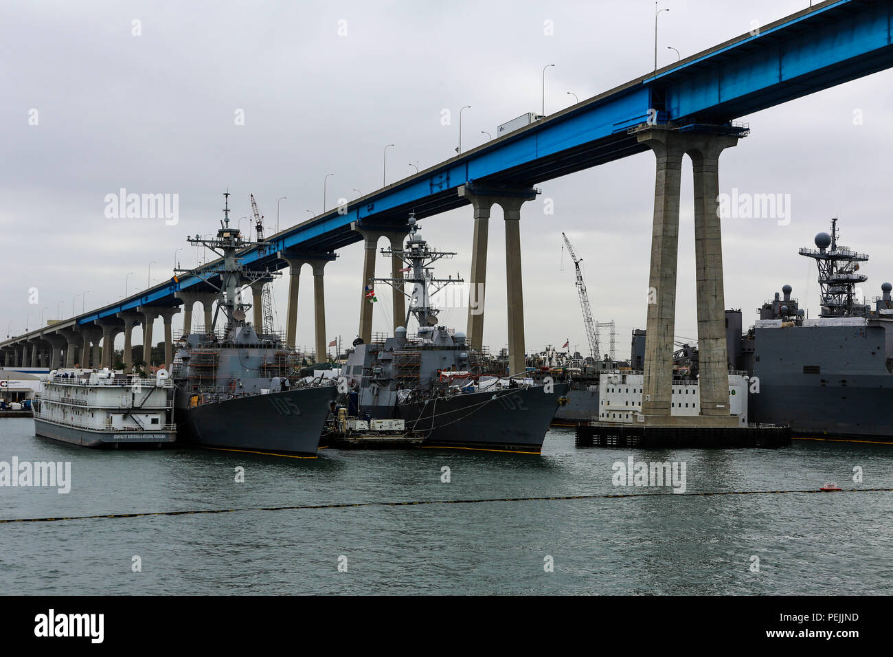 The amphibious assault ship USS Boxer (LHD 4) passes underneath the Coronado Bridge in San Diego, Calif., during Exercise Dawn Blitz 2015, Aug. 31, 2015. Dawn Blitz is a multinational amphibious training exercise designed to train Expeditionary Strike Group Three, 1st Marine Expeditionary Brigade and Coalition partners in the operations expected of an amphibious task force while also building U.S. and Coalition operational interoperability from the sea. (U.S. Marine Corps photo by Lance Cpl. April L. Price/Released) Stock Photo