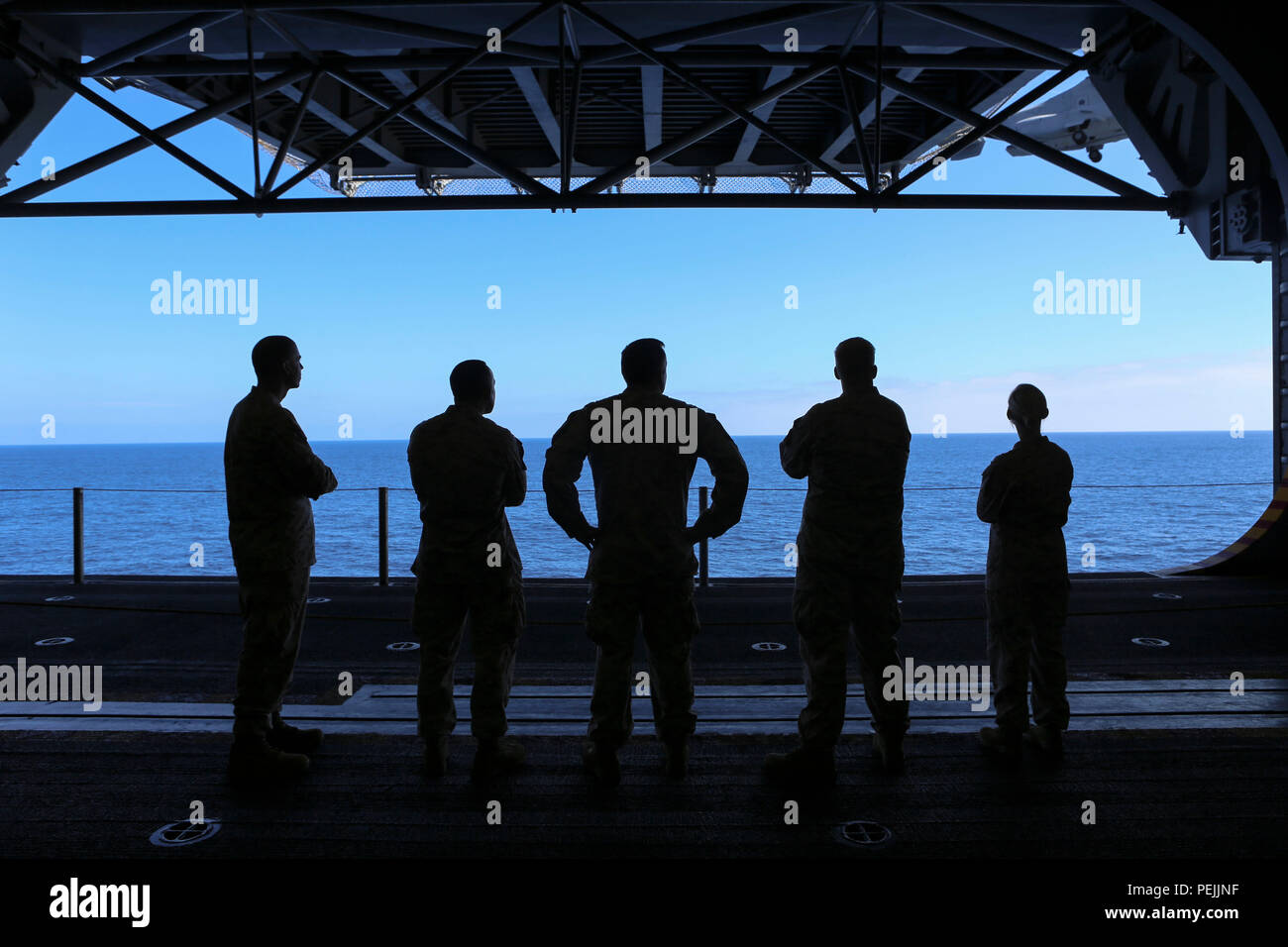 A group of Marines observe flight operations from the amphibious assault ship USS Boxer (LHD 4) during Exercise Dawn Blitz 2015, Aug. 31, 2015. Dawn Blitz is a multinational amphibious training exercise designed to train Expeditionary Strike Group Three, 1st Marine Expeditionary Brigade and Coalition partners in the operations expected of an amphibious task force while also building U.S. and Coalition operational interoperability from the sea. (U.S. Marine Corps photo by Lance Cpl. April L. Price/Released) Stock Photo