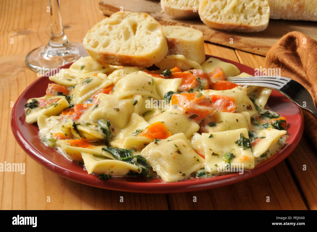 Lobster and ricotta ravioli with spinach and tomato in a buttery cream
