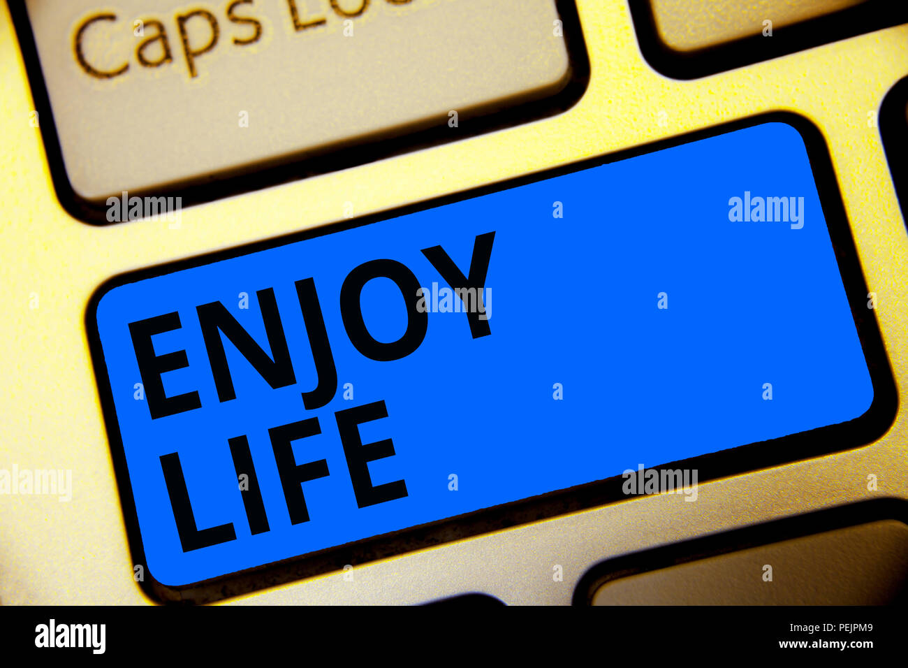 Writing note showing Enjoy Life. Business photo showcasing Any thing, place,food or person, that makes you relax and happy Keyboard blue key Intention Stock Photo