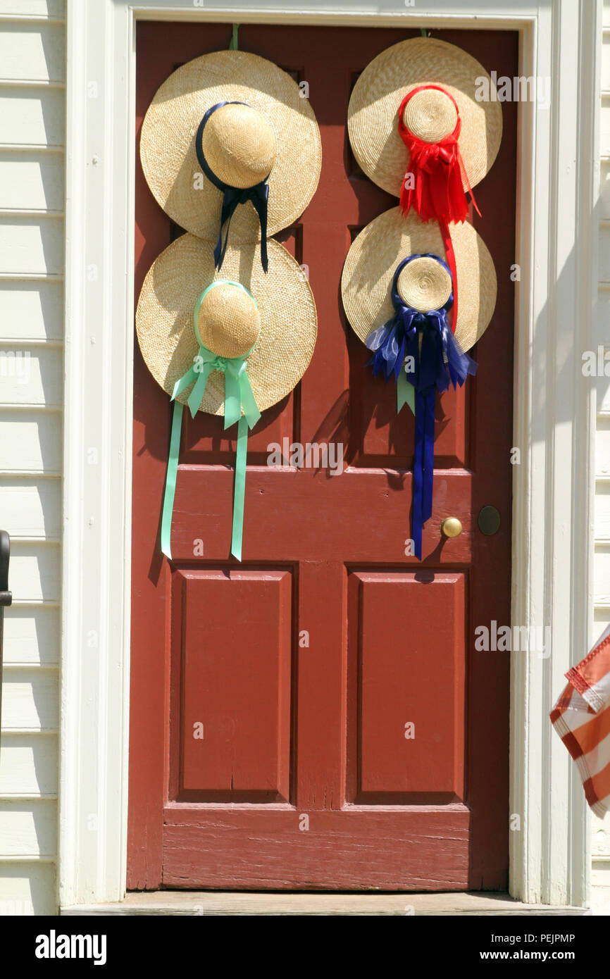 Straw hats decorating door in Colonial Williamsburg, VA, USA Stock