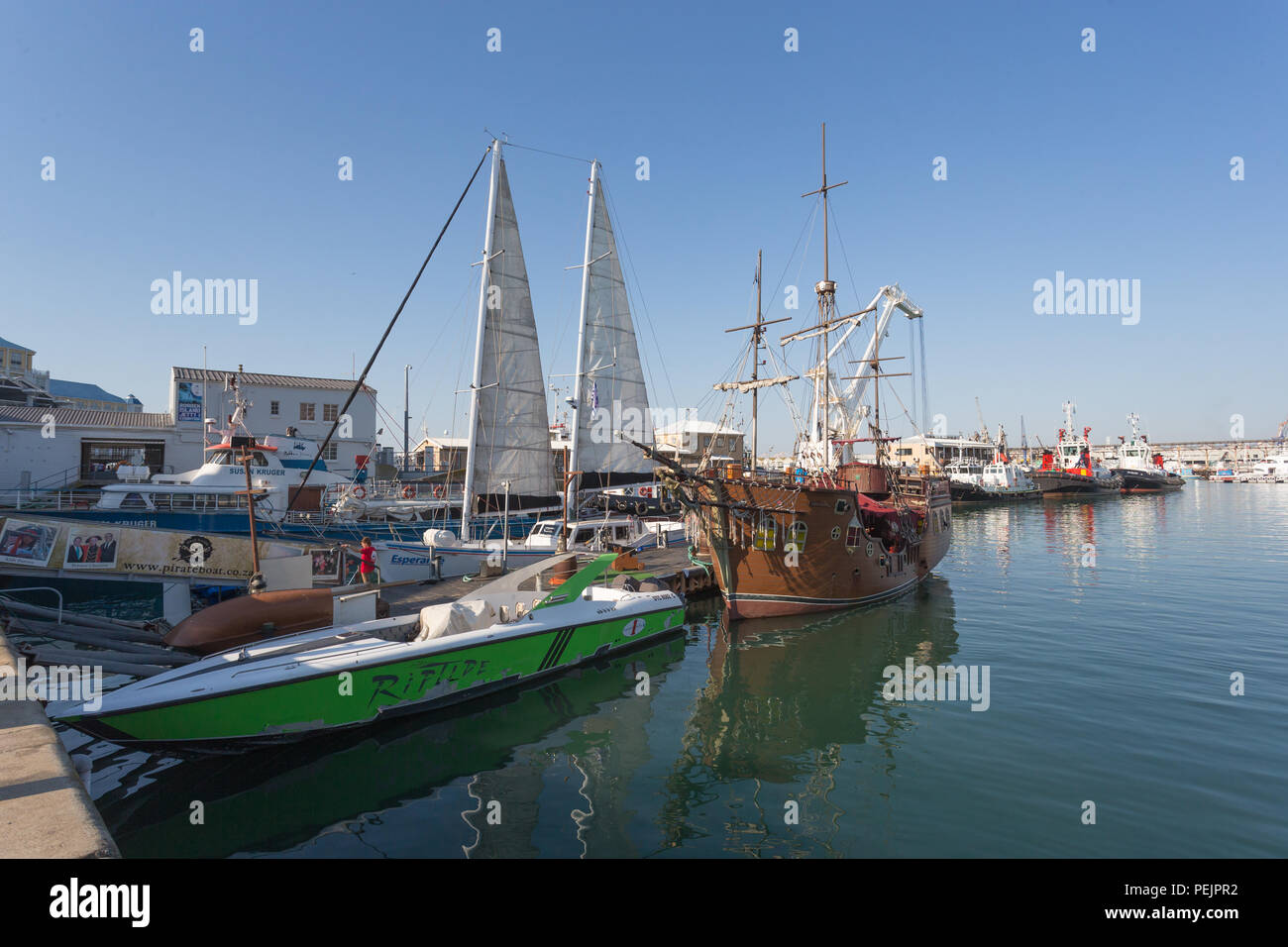 Moored pleasure  or recreational boats in the working harbour or harbor port of Cape Town at the V&A Waterfront South Africa Stock Photo