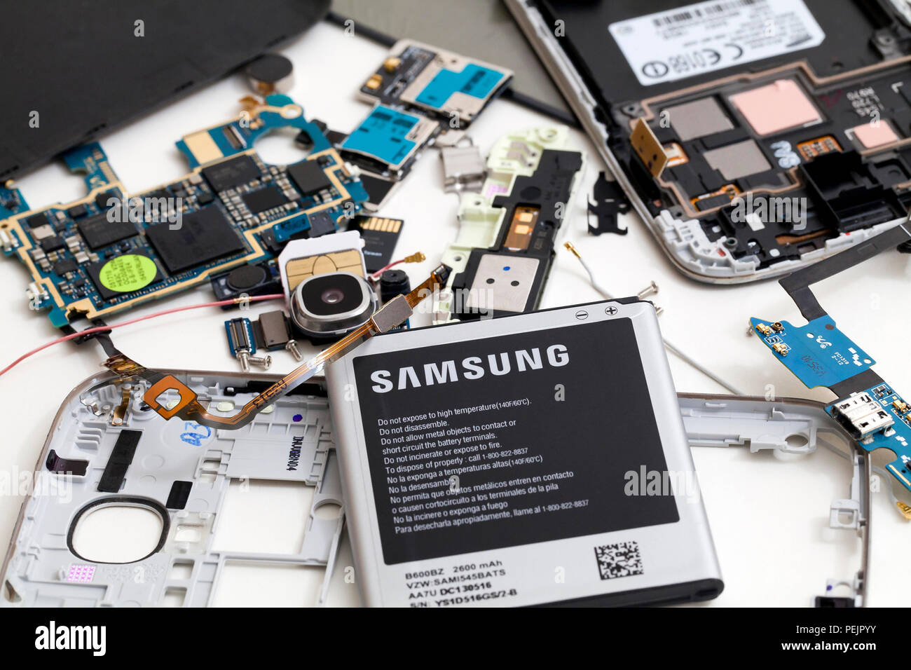 Disassembled Samsung Galaxy mobile phone, showing Samsung battery and various internal parts - USA Stock Photo