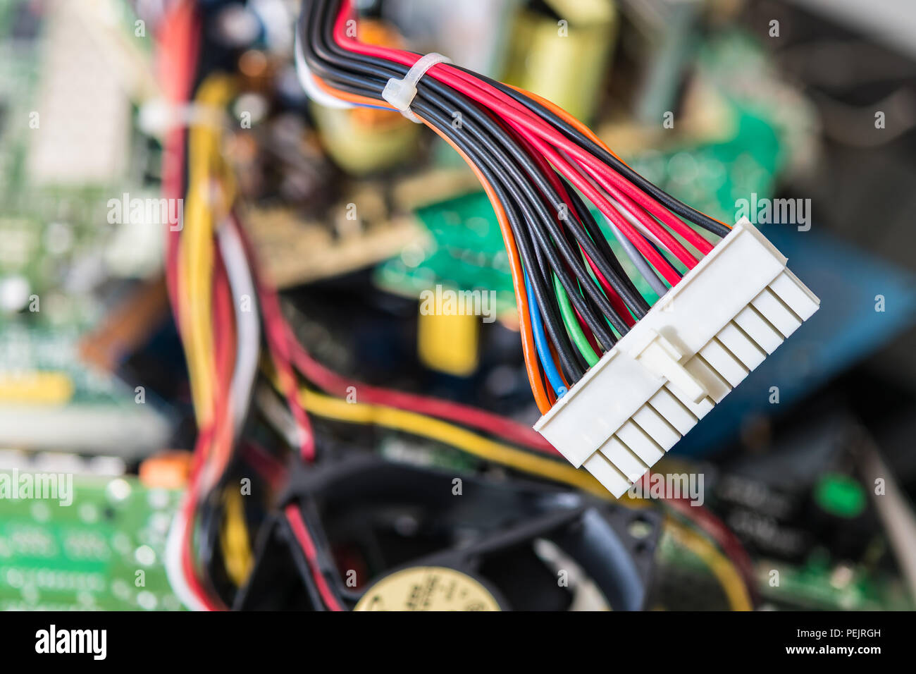 Connector with power cables for computer mainboard. Colorful blurry