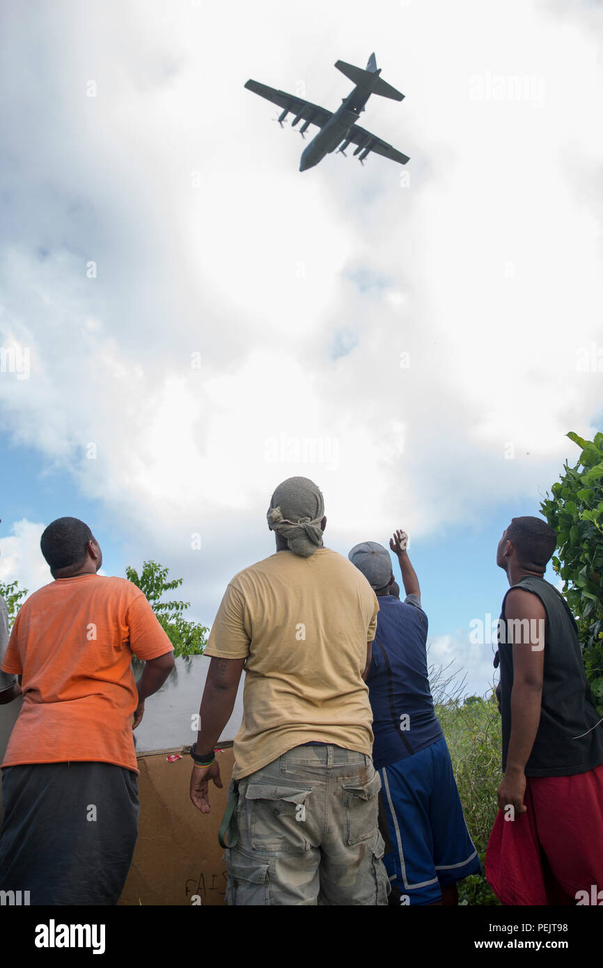 Islanders on Fais island, Federated States of Micronesia, wave to the aircrew of a C-130 Hercules assigned to the 36th Airlift Squadron after dropping a bundle of donated goods and supplies during Operation Christmas Drop 2015, Dec. 8, 2015. Airmen delivered over 800 pounds of supplies to the island of Fais during Operation Christmas Drop 2015. This year marks the first trilateral Operation Christmas Drop where the U.S. Air Force, Japan Air Self-Defense Force and the Royal Australian Air Force work together to provide critical supplies to 56 Micronesian islands impacting 20,000 islanders. (U.S Stock Photo