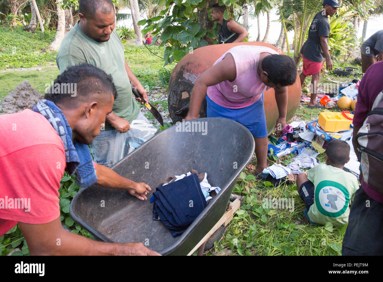 Villages load and sort the donated supplies that were dropped during Operation Christmas Drop 2015, Dec. 8, 2015, at Fais Island, Federated States of Micronesia. Operation Christmas Drop is a humanitarian/disaster relief training event where C-130 crews provide critical supplies to 56 islands throughout the Commonwealth of the Northern Marianas, Federated States of Micronesia and Republic of Palau. This year marks the first ever trilateral execution that includes air support from the U.S. Air Force, Japan Air Self-Defense Force and the Royal Australian Air Force. (U.S. Air Force photo by Osaka Stock Photo