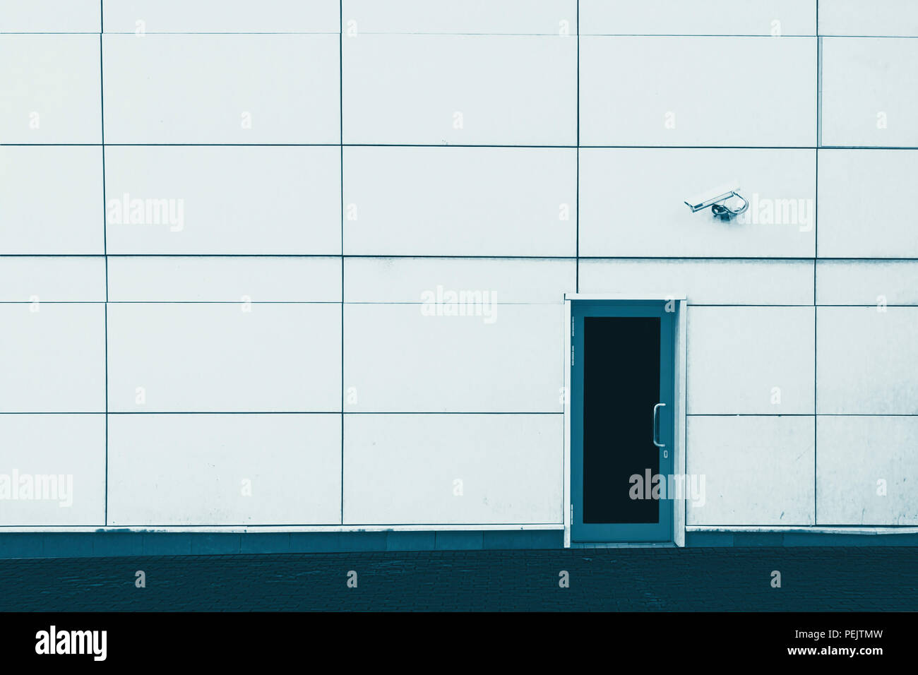 wall of the building, the door and the CCTV camera. Security. Blue ...