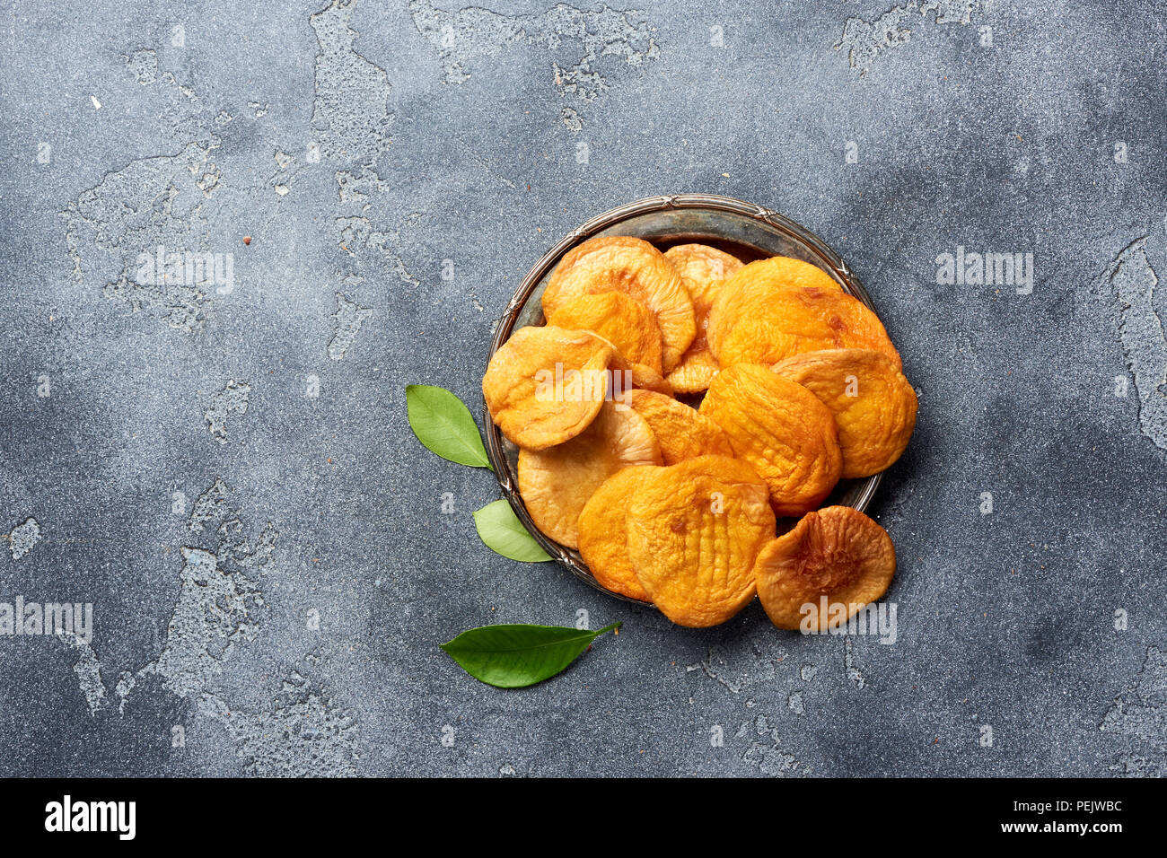 Dried apricots on gray background. Top view. Stock Photo