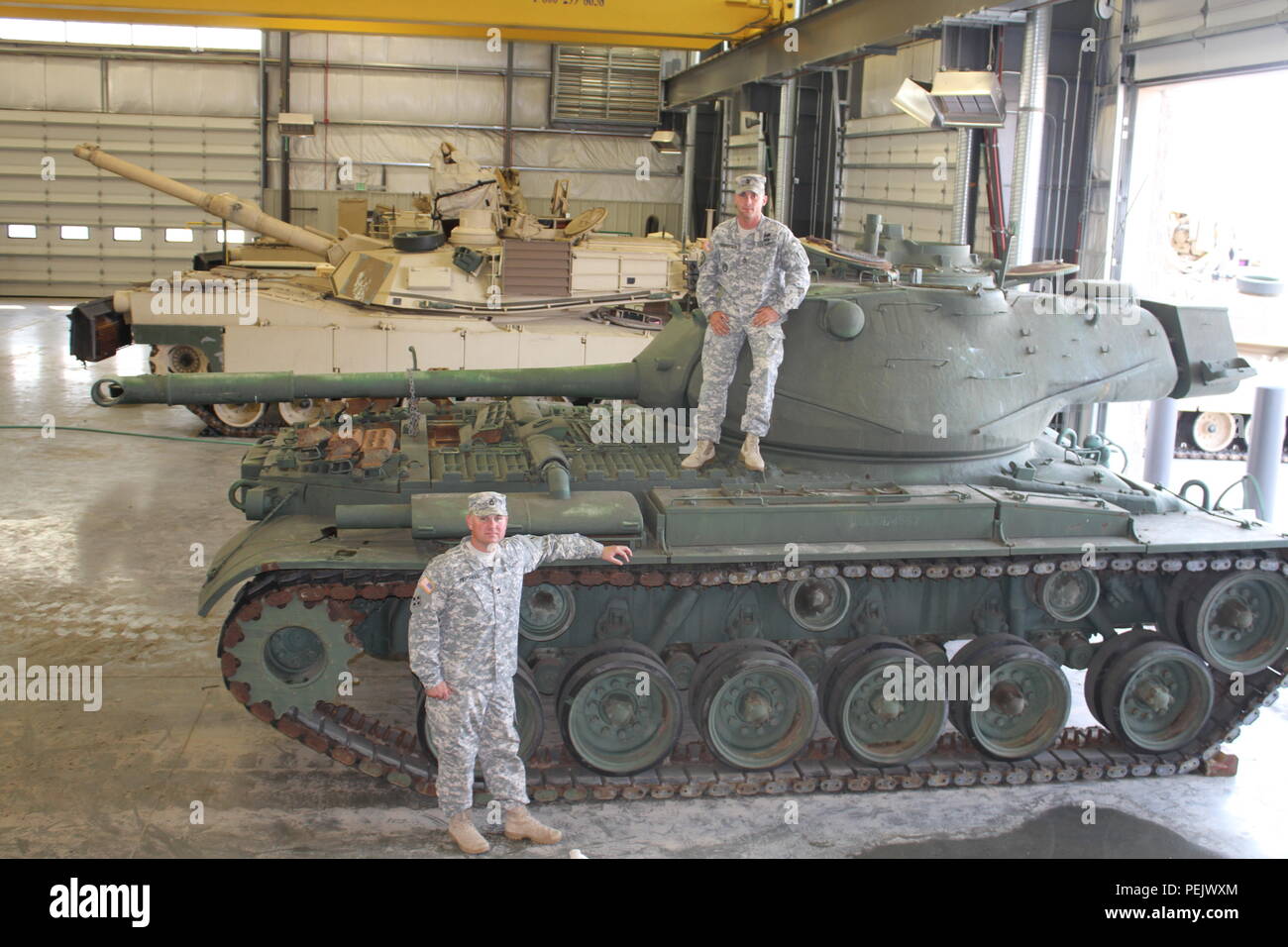 Sgt. 1st Class Clint Mitchell, left, and Sgt. 1st Class David Henderson, right, both Abrams tank system maintainers with the 3rd Battalion, 66th Armor Regiment, 1st Armored Brigade Combat Team, 1st Infantry Division, pose with two M47 Patton Tanks Aug. 26 at Fort Riley. The 'Black Knights' will display the tanks in front of the headquarters’ motor pool. Stock Photo