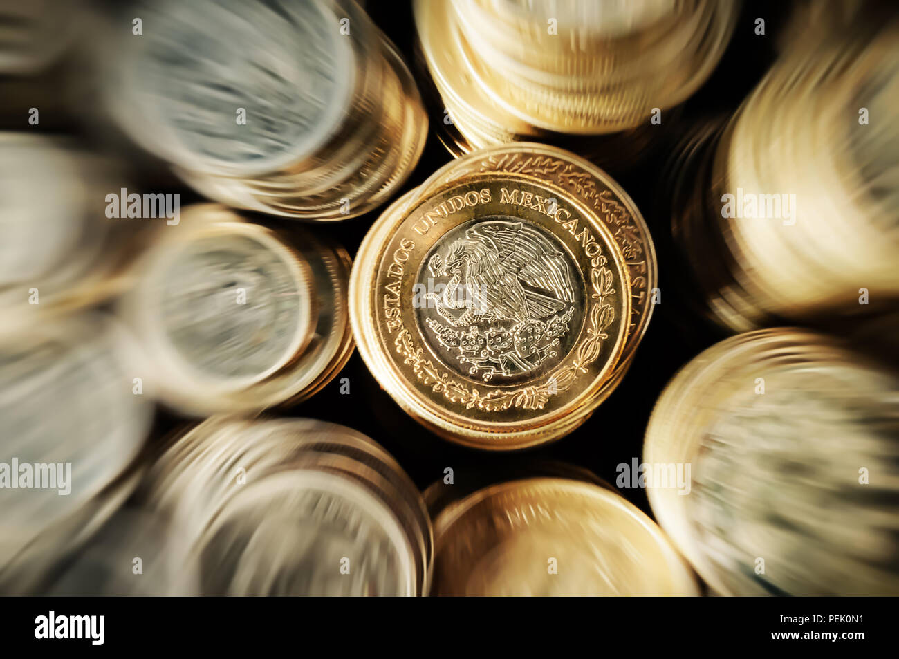 Zoom in to Mexican peso coin stacked on the eagle face side Stock Photo