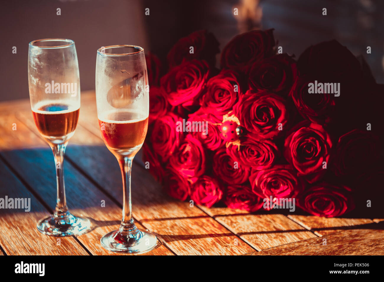 Couple red roses champagne hi-res stock photography and images - Alamy