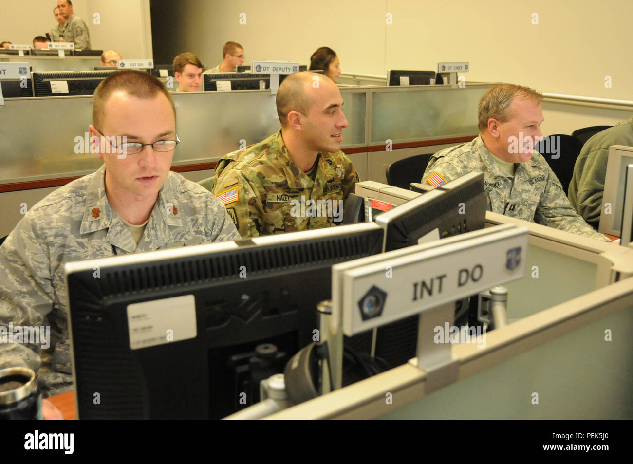 U.S. Army Captains Brian Haley, center, and Matthew Sosnowski, right, of the 32nd Army and Air Missile Defense Command, Fort Bliss, Texas, train side-by-side with U.S. Air National Guard Maj. Patrick Lamie, left, during simulated theater missile defense operations at exercise Virtual Flag. The exercise was held Dec. 2-10, 2015, at the 183d Fighter Wing in Springfield, Ill.  The Illinois Air National Guard unit conducted joint training scenarios with the U.S. Air Force, Army, and Navy as part of the air operations portion of the simulated battlefield exercise.  More than 350 personnel participa Stock Photo
