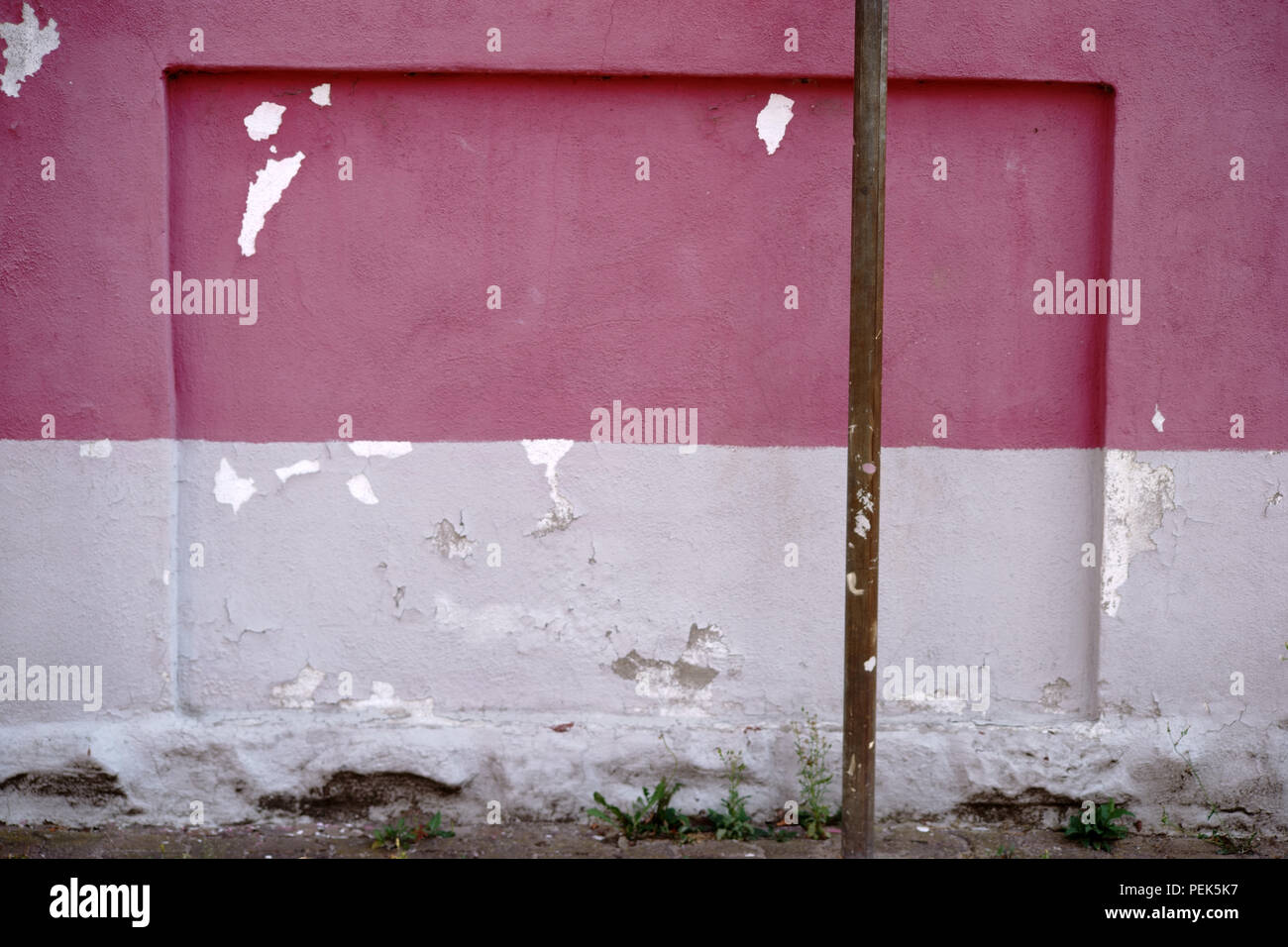 The close up of a wall with a chipped plaster layer. Stock Photo