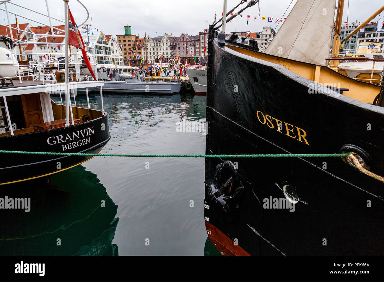 Two veteran passenger steam ships in the port of Bergen, Norway; bow of Oster (b.1908) and stern of Granvin (b.1931) Fjordsteam 2018 Stock Photo