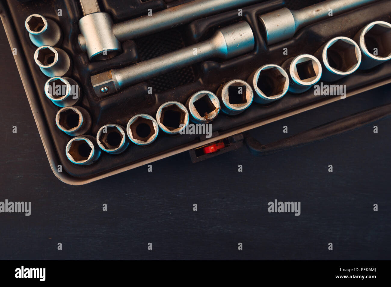 Old used socket tool box with accessories top view ratchets with