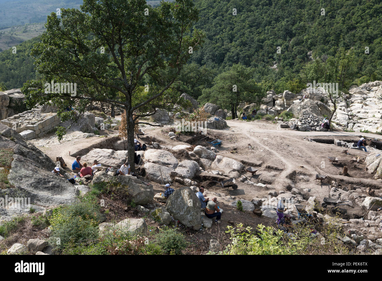Workers digging at ancient excavation site with Thracian and Greek remnants, Perperikon,Bulgaria Stock Photo