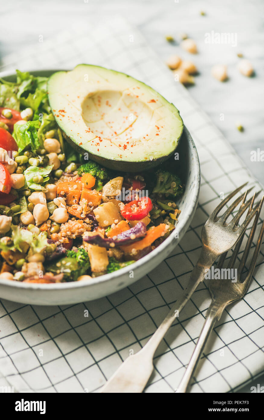 Vegan dinner with avocado, grains, beans and vegetables Stock Photo