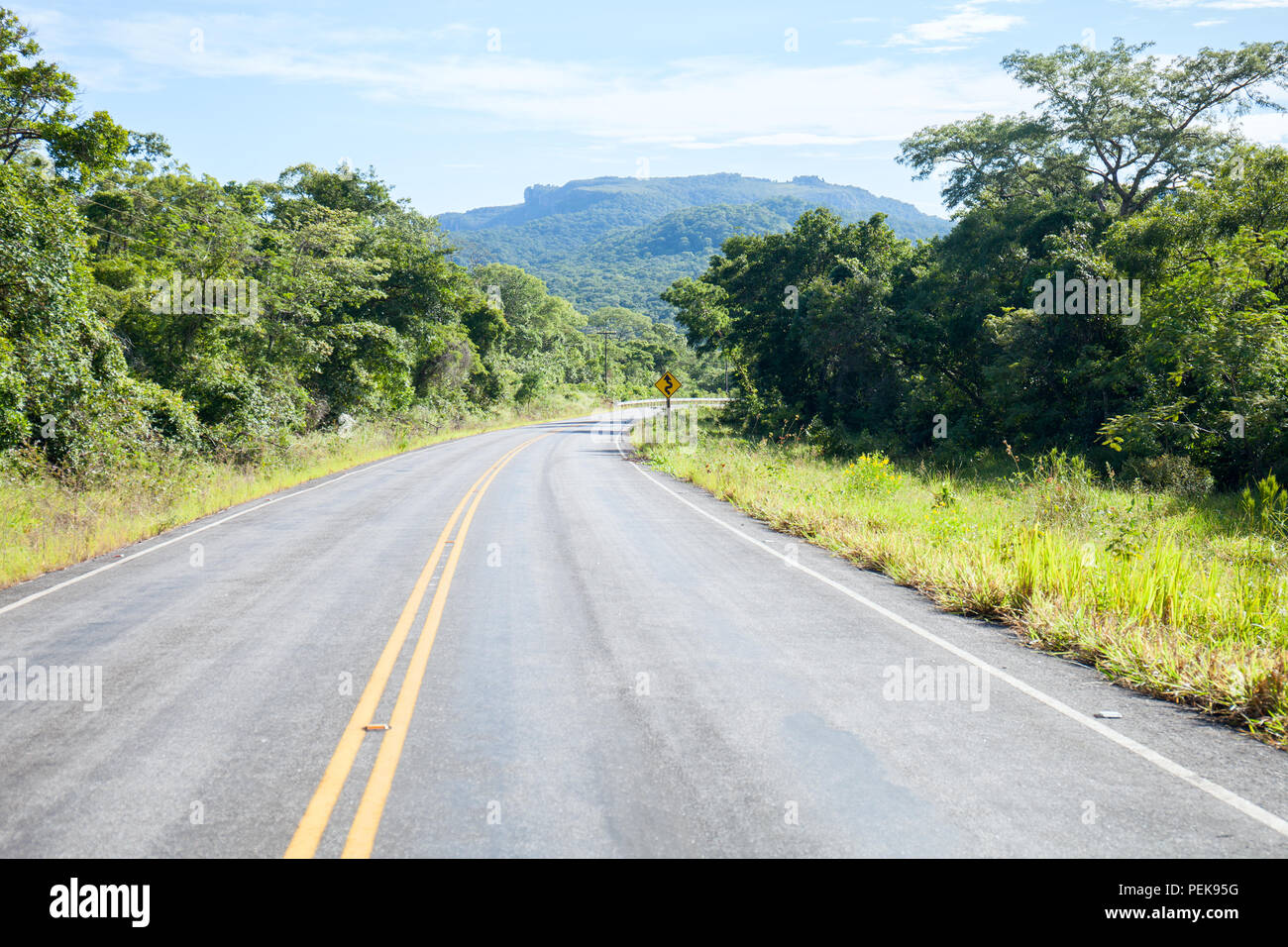 Empty Asphalt road in the Bolivian forests and sky Stock Photo