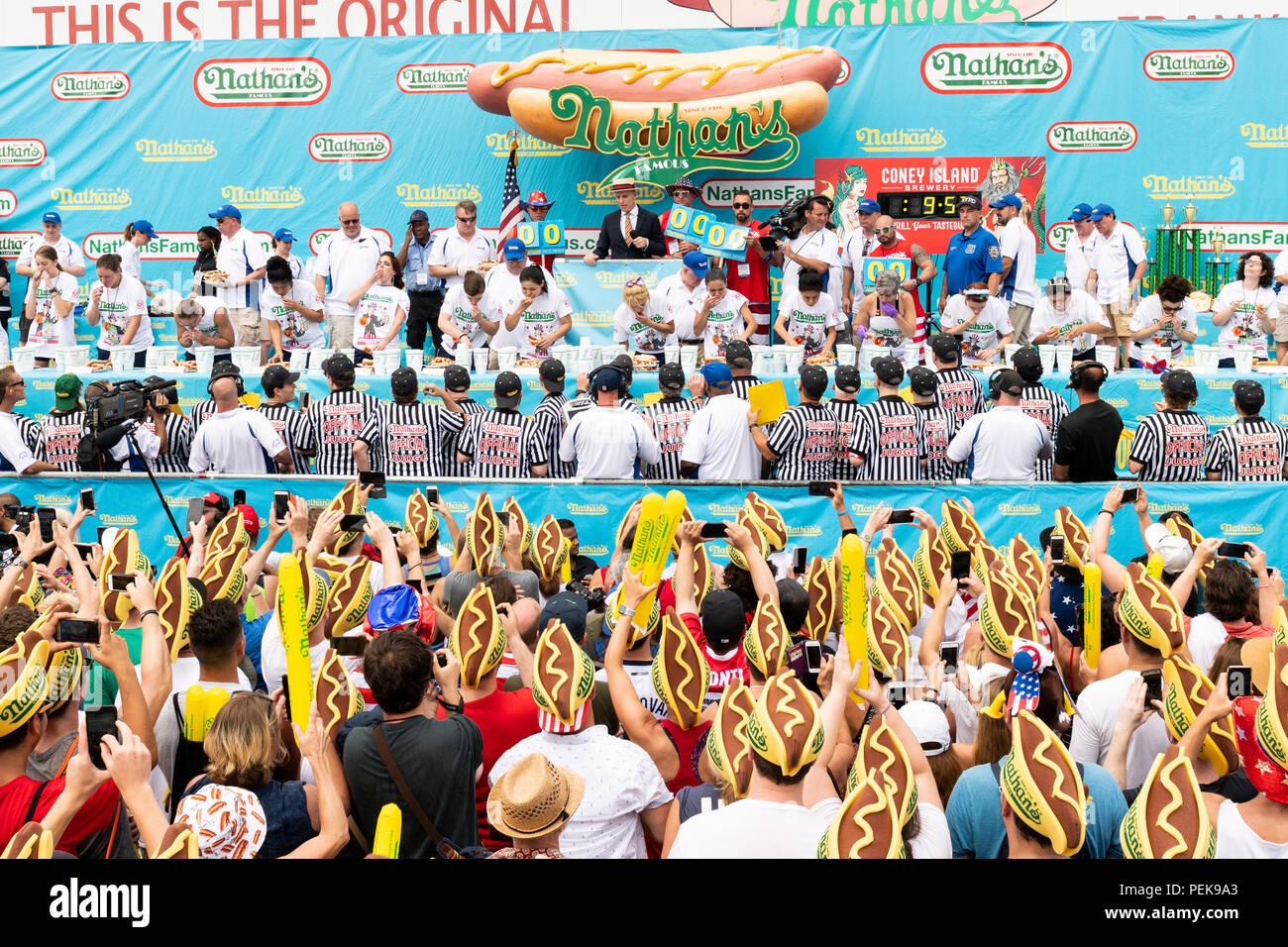 Miki Sudo (blonde hair, in the center) ate 37 hot  dogs and buns in ten minutes  to win the women's division of the 2018 Nathan’s Famous International Stock Photo