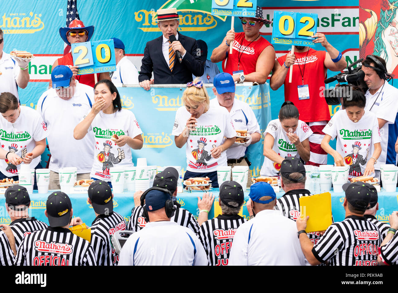 Miki Sudo (blonde hair, in the center) ate 37 hot  dogs and buns in ten minutes  to win the women's division of the 2018 Nathan’s Famous International Stock Photo