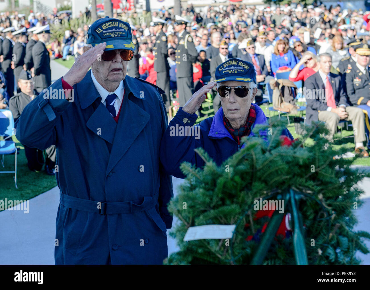 151212-N-QW941-088  SAN DIEGO (Dec. 12, 2015) World War 2 combat veterans salute to pay their respects to fallen military members during the Wreaths Across America ceremony at Fort Rosecran’s National Cemetery. Wreaths Across America is an annual event that takes place in multiple locations where volunteers lay wreaths on tombstones of fallen military members. (U.S. Navy photo by Mass Communication Specialist 3rd Class Trevor Kohlrus/Released) Stock Photo
