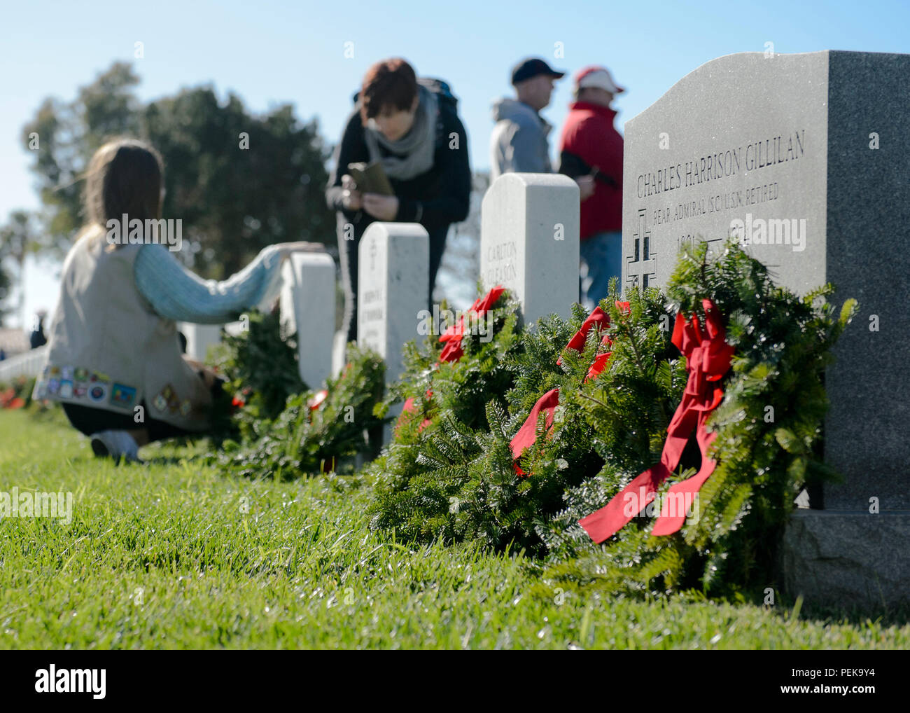 151212-N-QW941-188  SAN DIEGO (Dec. 12, 2015) Military service members, friends and family participate in a Wreaths Across America ceremony at Fort Rosecran’s National Cemetery. Wreaths Across America is an annual event that takes place in multiple locations where volunteers lay wreaths on tombstones of fallen military members. (U.S. Navy photo by Mass Communication Specialist 3rd Class Trevor Kohlrus/Released) Stock Photo