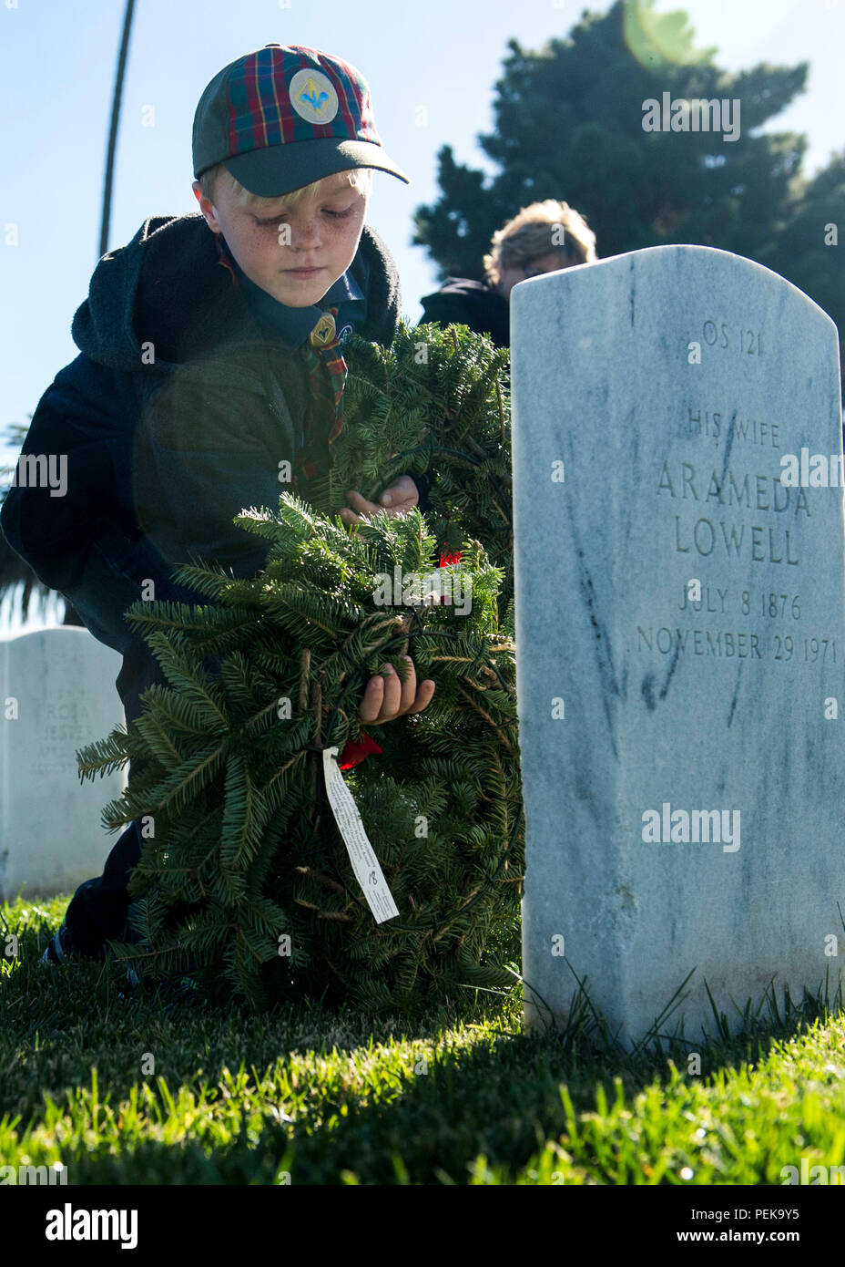 151212-N-QW941-191  SAN DIEGO (Dec. 12, 2015) An American Boy Scout lays a wreath on the tombstone of a fallen military member at Fort Rosecran’s National Cemetery during the Wreaths Across America ceremony. Wreaths Across America is an annual event that takes place in multiple locations where volunteers lay wreaths on tombstones of fallen military members. (U.S. Navy photo by Mass Communication Specialist 3rd Class Trevor Kohlrus/Released) Stock Photo