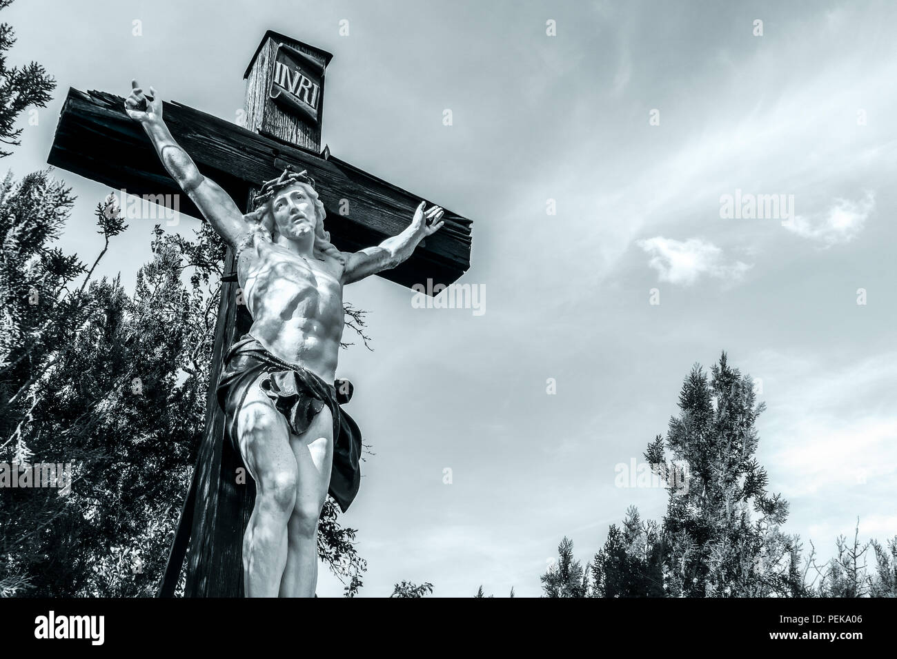 Black and white or monochrome picture of a big crucifix of Jesus-Christ with copy space, outdoor, Alsace, France. Stock Photo