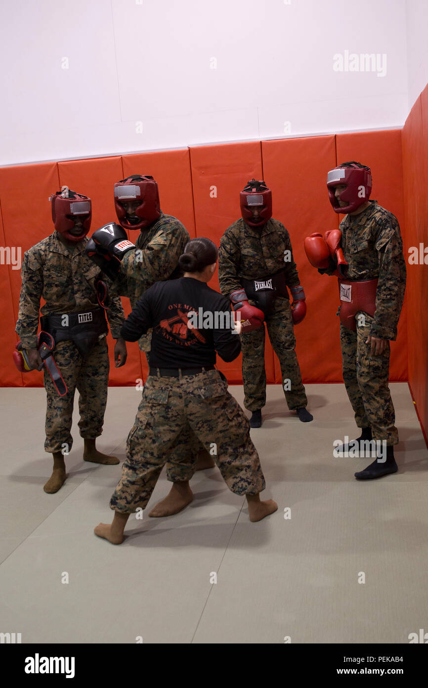 Sgt. Chayna McGurn, center, demonstrates a Marine Corps Martial Arts Program technique to