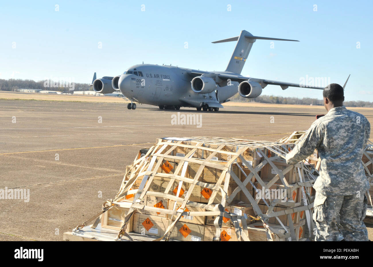 Soldiers with Company C, 2nd Battalion, 20th Special Forces Group (Airborne), Mississippi Army National Guard prepare to load an Air Force C-17 Globemaster aircraft to deploy to Southwest Asia December 14, 2015 at Grenada Municipal Airport in Grenada, Miss. This is the first time that Mississippi National Guard has used the former World War II Airfield to deploy Soldiers. (Mississippi National Guard photo by Staff Sgt. Shane Hamann, 102nd Public Affairs Detachment/Released) Stock Photo