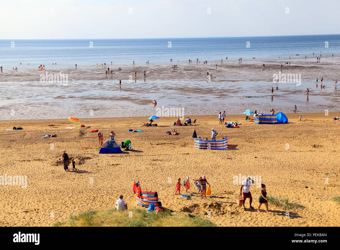 Old Hunstanton Beach, families, paddling, sunbathing, sandy, low tide, Norfolk, UK Stock Photo