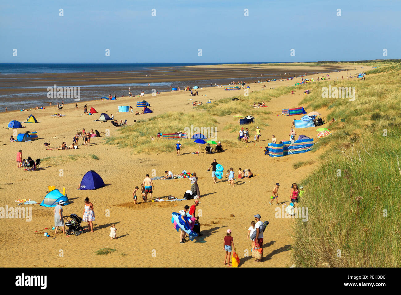 Old Hunstanton, beach, sand, bay, sunbathers, sunbeds, North Sea, coast, Norfolk, England, UK Stock Photo