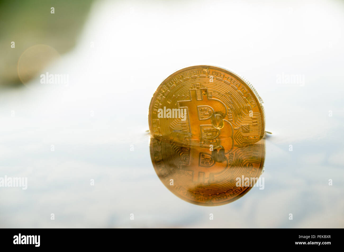 Bitcoin crypto currency sinking down with bear trends Stock Photo