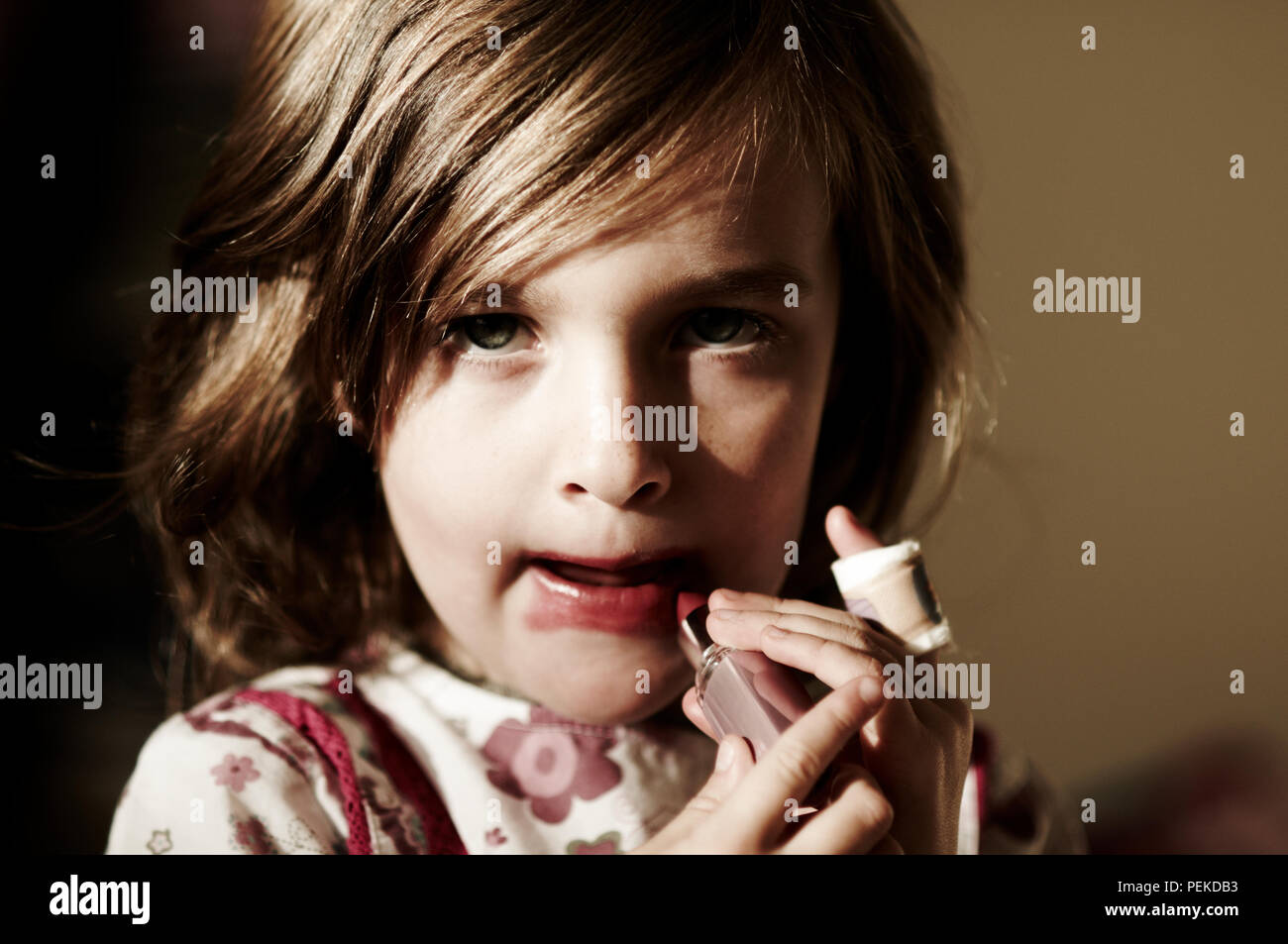 Little girl putting lipstick on hires stock photography and images Alamy