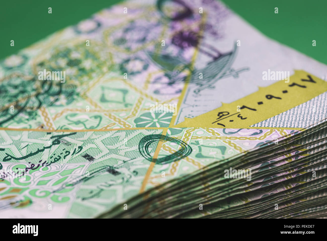 Close up of 5 Qatari Riyal bank note with selective focus. Stock Photo