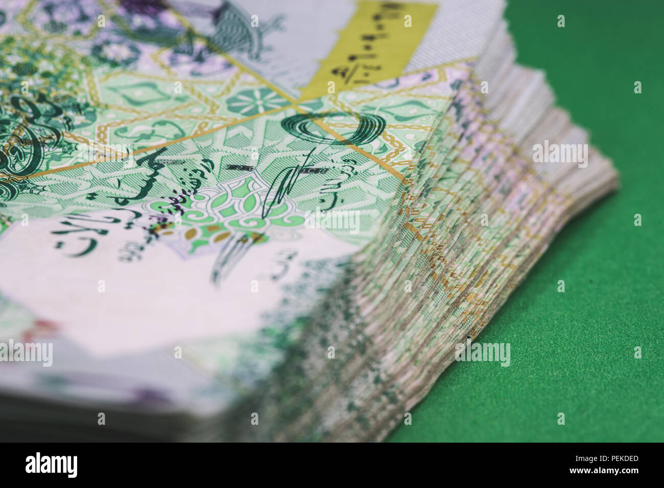 Close up of 5 Qatari Riyal bank note with selective focus. Stock Photo