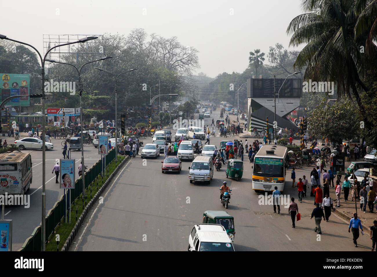 Pedestrians cross a busy road putting their lives at risk. Dhaka, Bangladesh Stock Photo