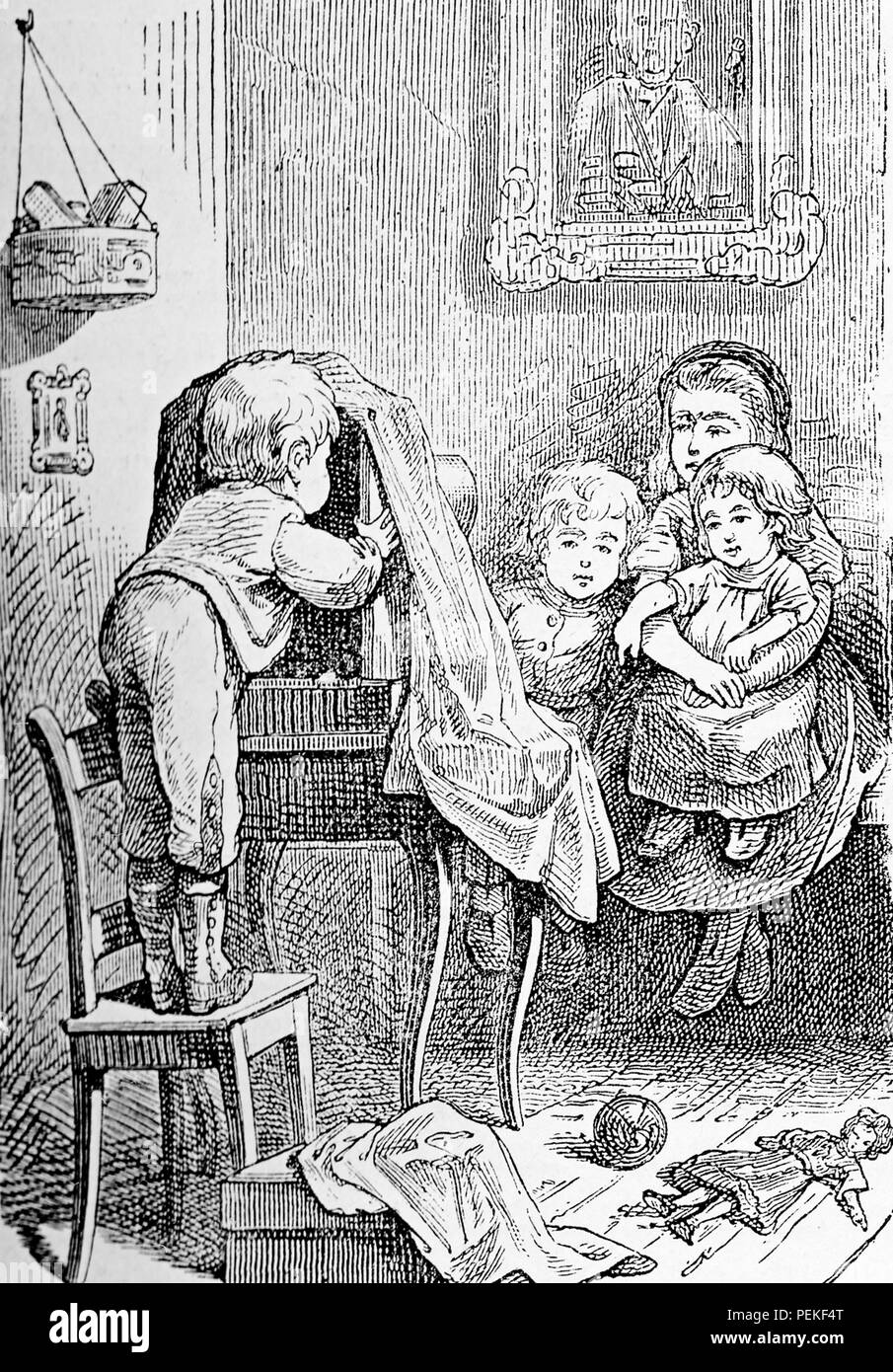 Vintage caricature and humor: children game, the small photographer mimicking at home an atelier Stock Photo