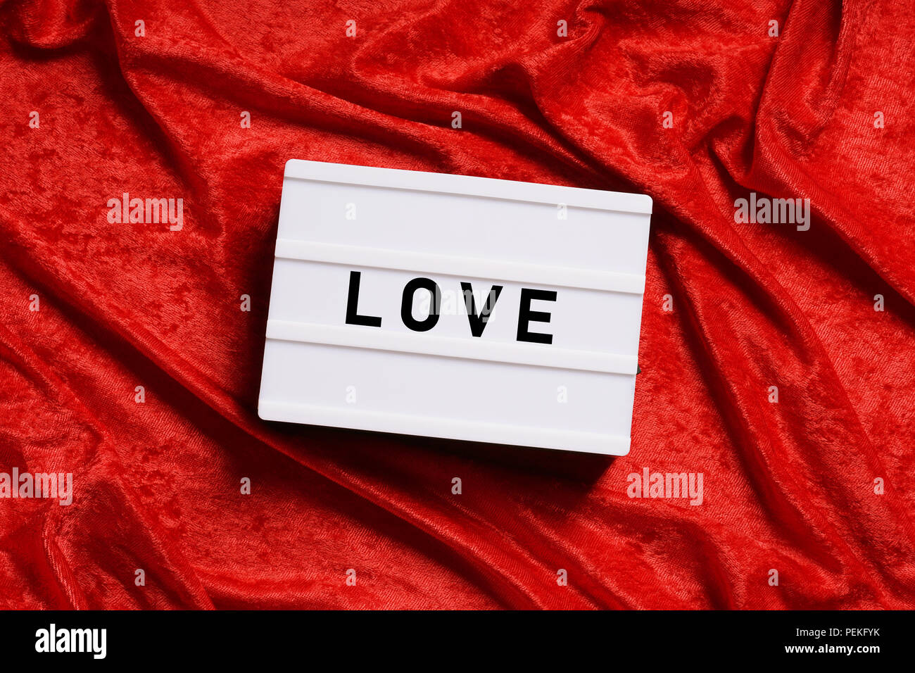 love, word on lightbox or light box sign on red velvet background Stock Photo