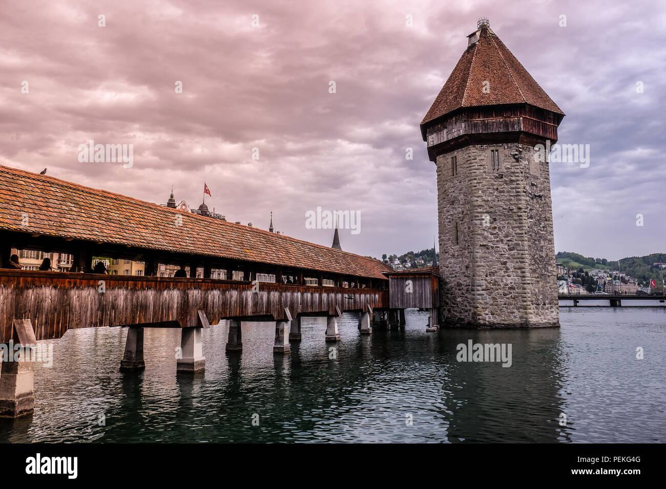 Landscape view of the Kapellbrücke (chapel Bridge), in the city of Luzern in Switzerland, with mountains in the background Stock Photo
