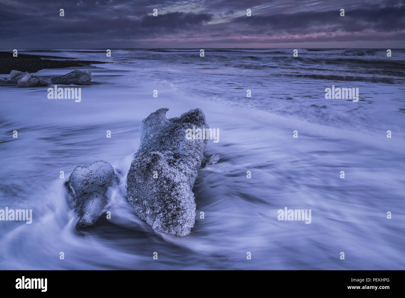 Glacial Ice washed ashore on the beach at Jokulsarlon Black Sand Beach also known as Breidamerkursandur, Iceland Stock Photo