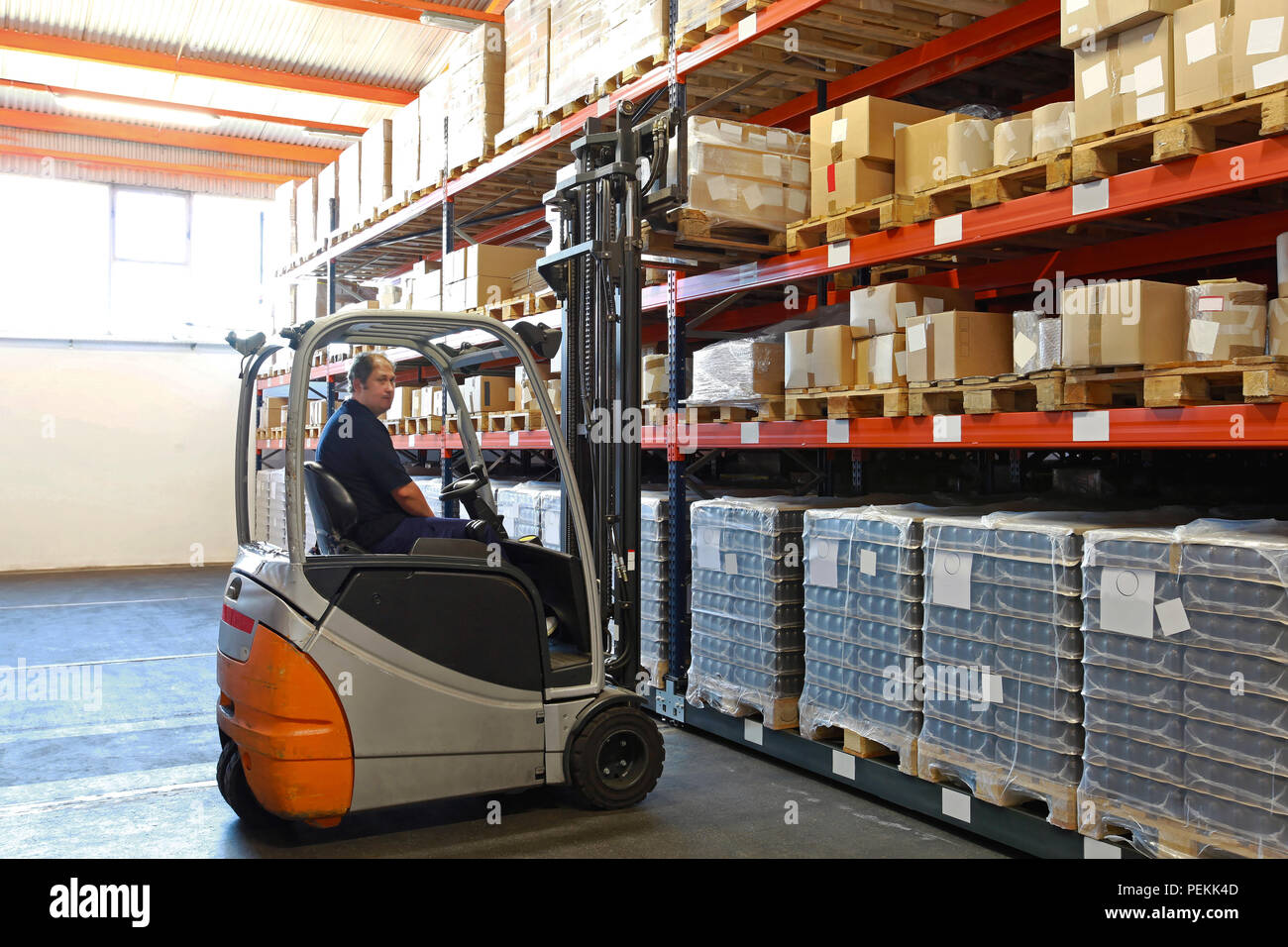 Electric forklift in distribution warehouse Stock Photo