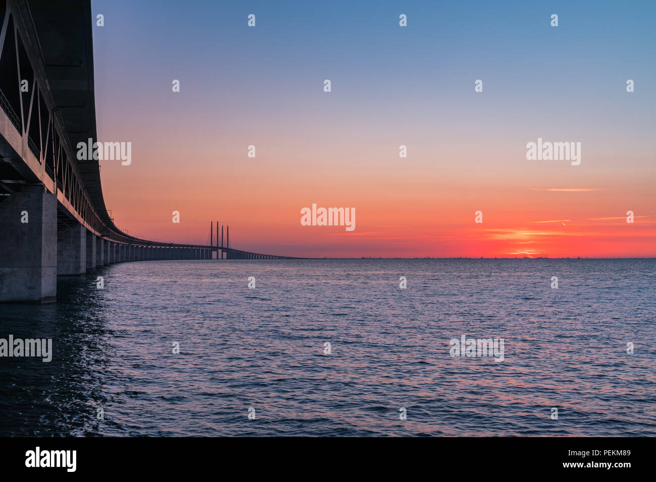 The Oresund Bridge is the longest combined road and rail bridge in Europe and connects two major cities: Copenhagen and Malmo. Stock Photo