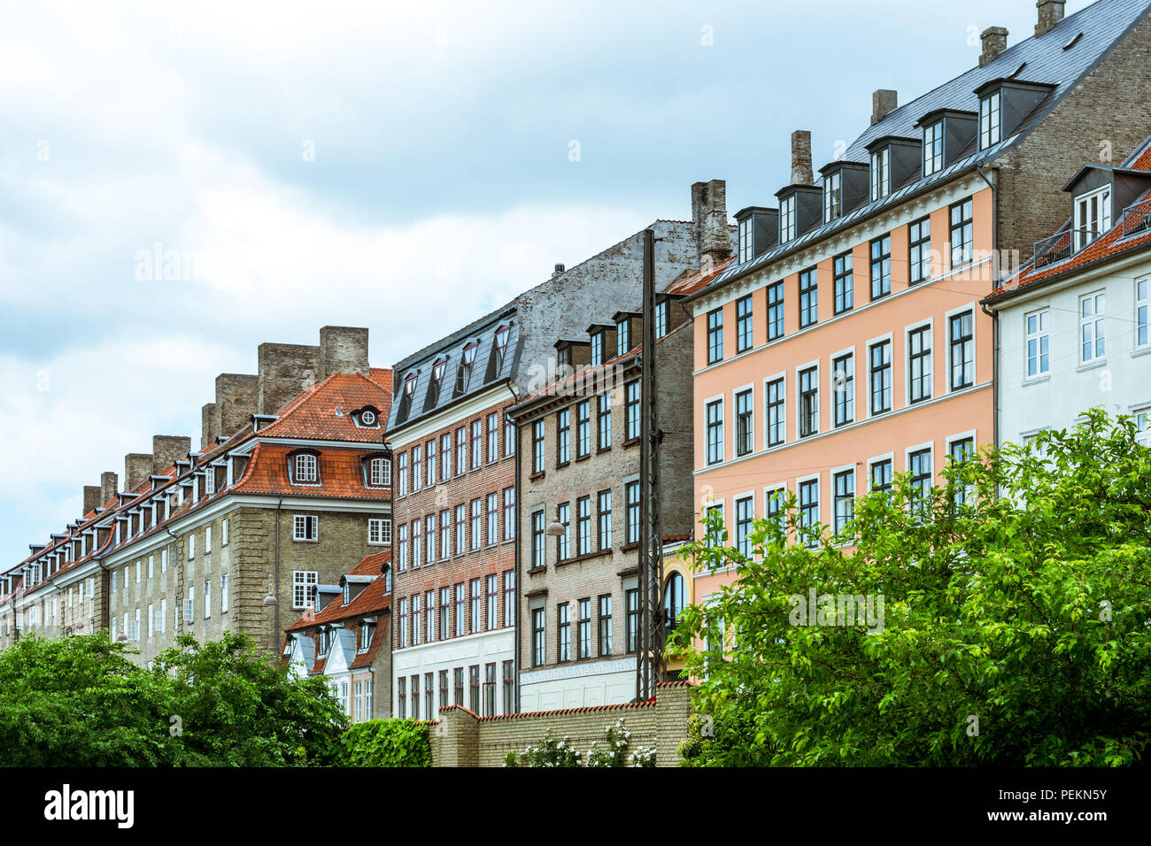 A row of colourful houses, in copenhagan, denmark, on a cloudy day Stock Photo