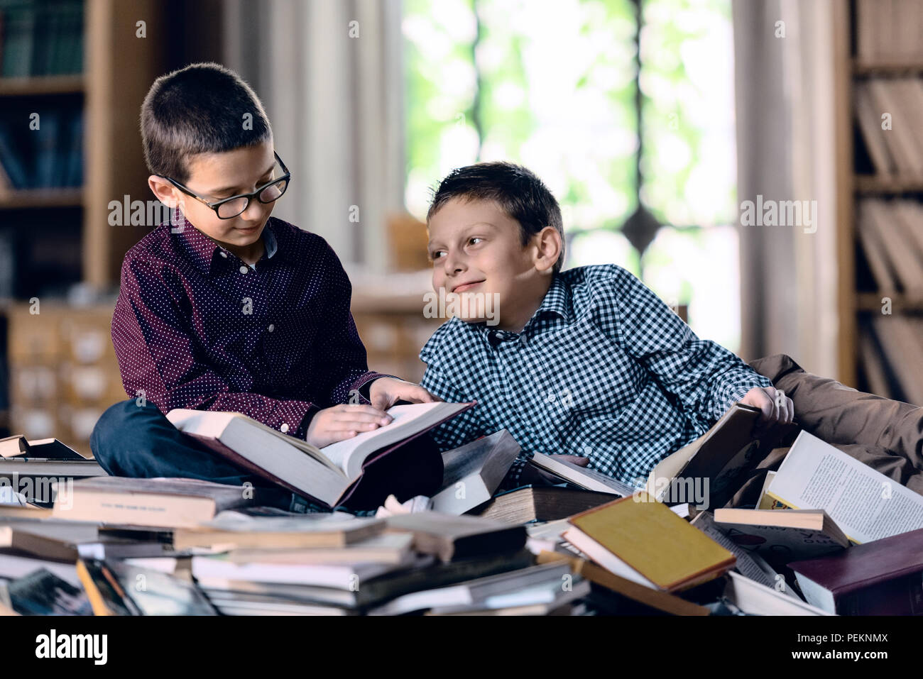 little boys reading books in the library Stock Photo