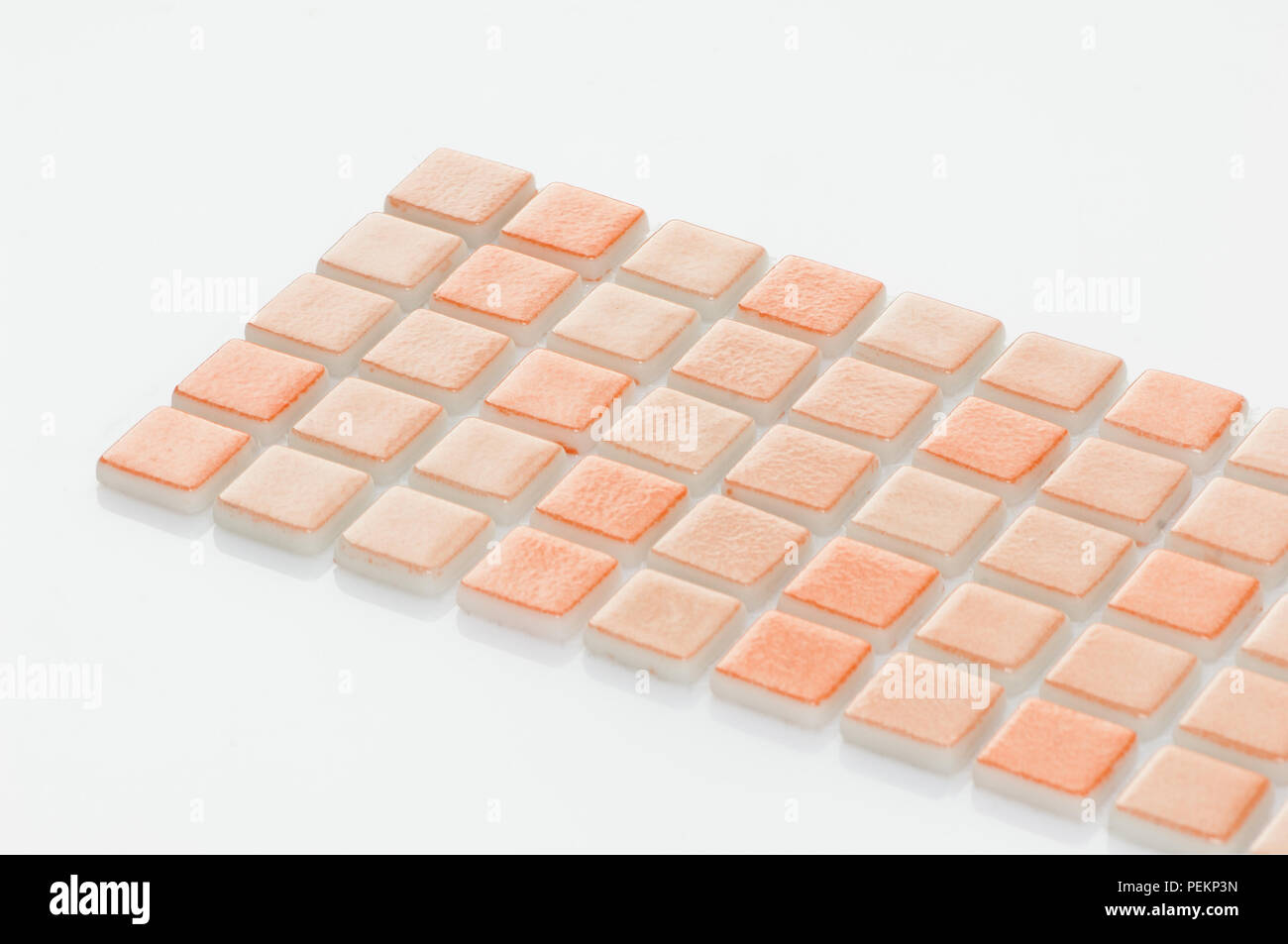 little orange ceramic tile on a white background, majolica. for the catalog Stock Photo