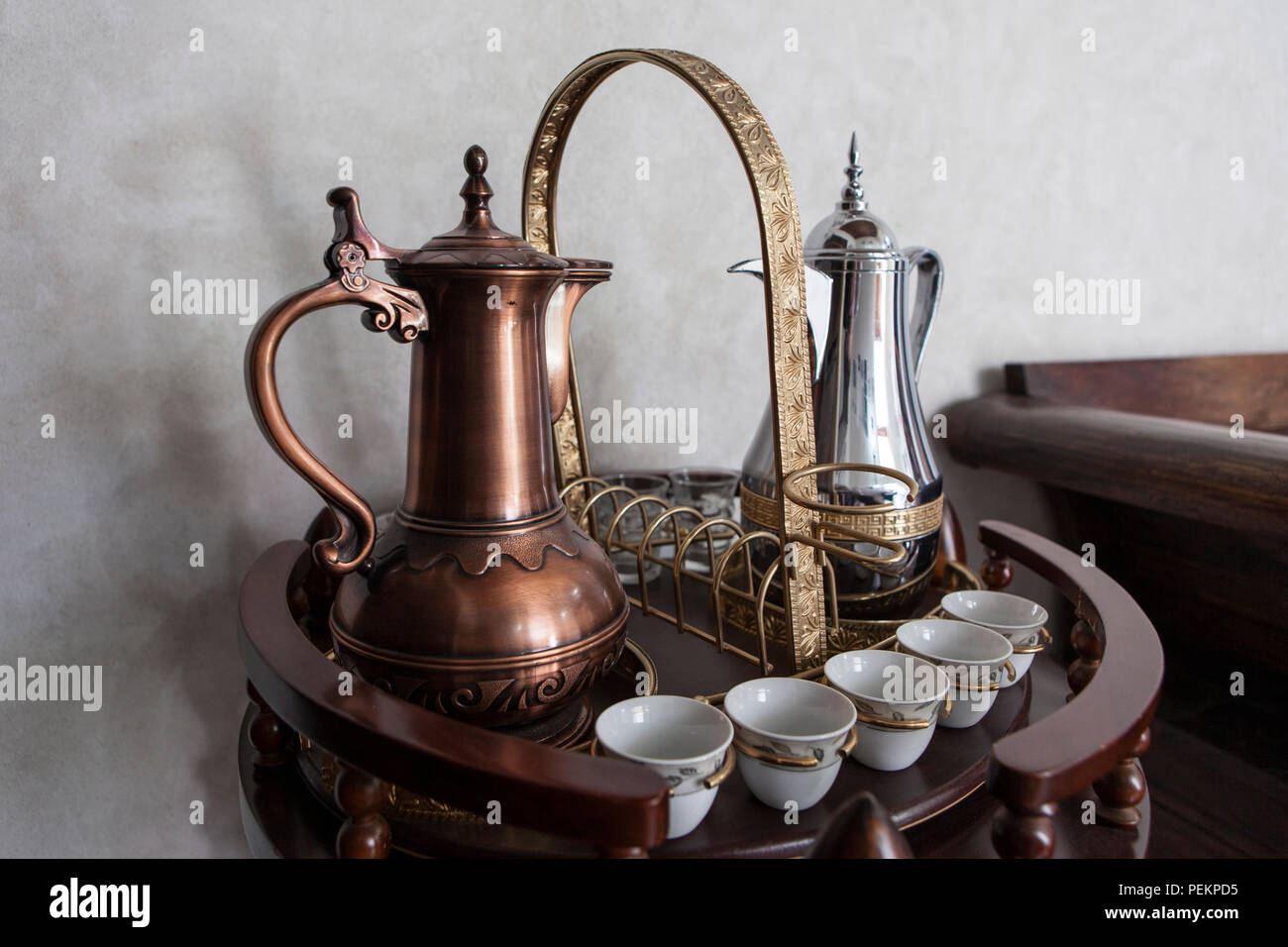 Two traditional Arabic coffee pots, with accompanying cups, Dubai, United  Arab Emirates Stock Photo - Alamy